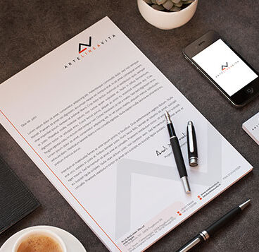 A design agency's business stationery set with a cup of coffee and a phone.