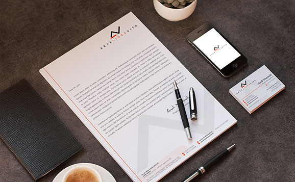 A design agency's business stationery set with a cup of coffee and a phone.